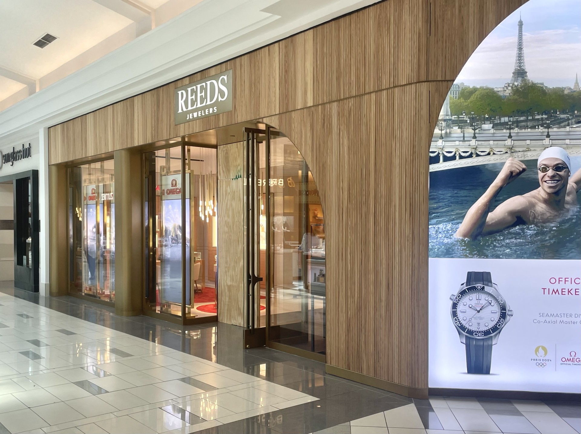 Reeds Jewelers commercial glass and metal storefront installation with wood façade in shopping mall