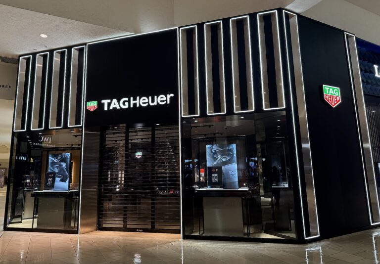 TAG Heuer retail storefront with custom glass and metal glazing and illuminated exterior design in a luxury shopping mall