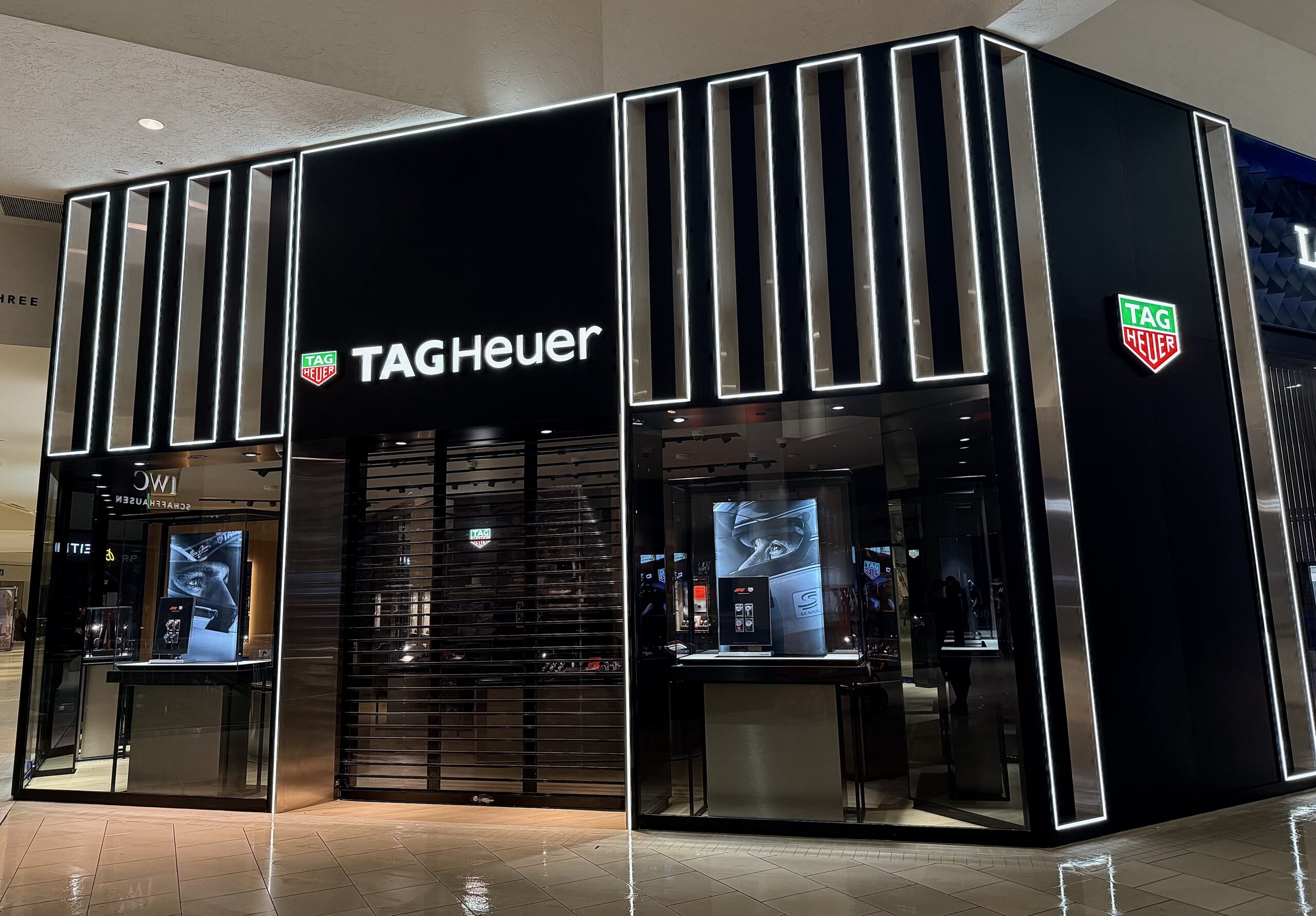 TAG Heuer retail storefront with custom glass and metal glazing and illuminated exterior design in a luxury shopping mall