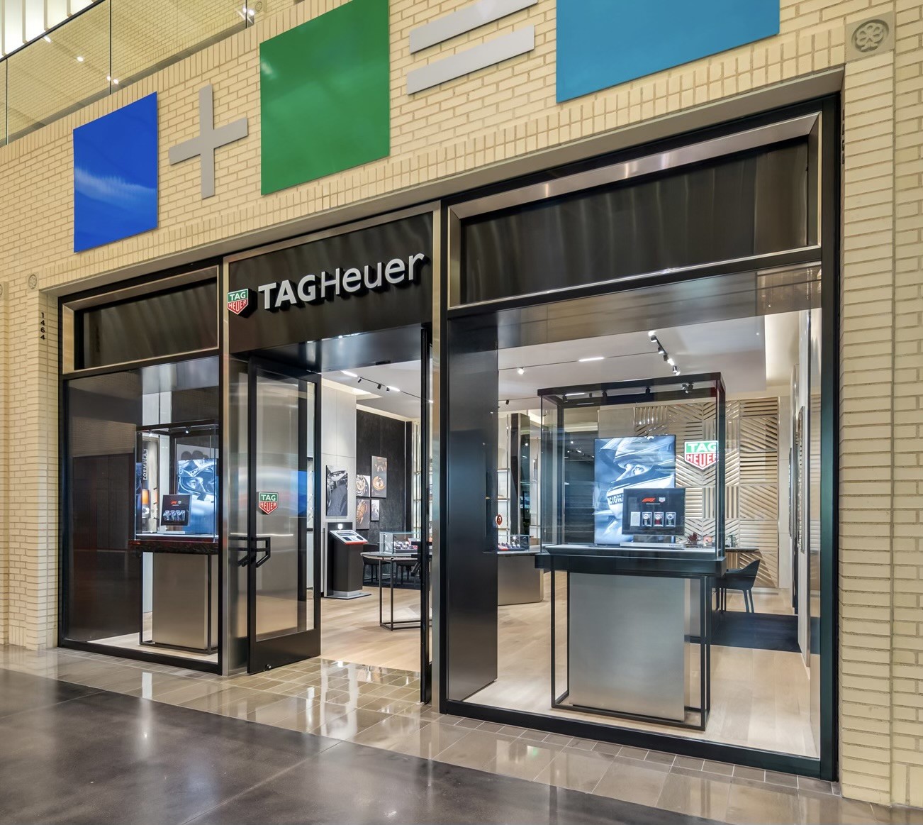 Modern TAG Heuer storefront with custom glass and metal façade at Dallas NorthPark mall, showcasing high-end retail glazing and sleek commercial storefront design.